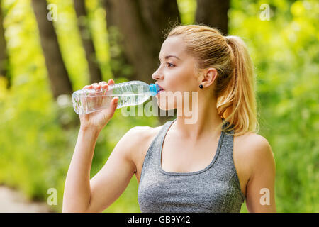 Donna sportiva acqua potabile. Foto Stock