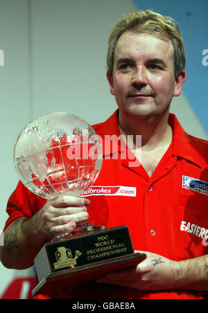 Phil Taylor con il trofeo dopo aver vinto la finale per l'undicesima volta Foto Stock