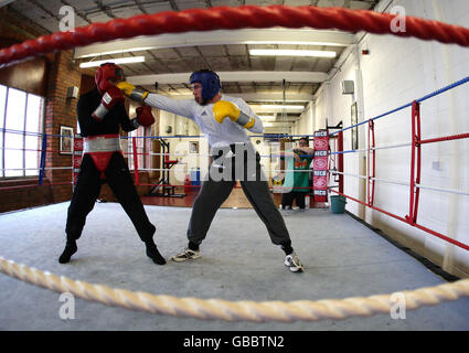 L'ex campione del peso medio WBU Anthony Farnell, a destra, guarda Frankie Gavin, centro, zampilla con Anthony Crolla, a sinistra, nella sua palestra a Failsworth, Manchester. Farnell ora forma giovani lottatori professionisti in palestra. Foto Stock