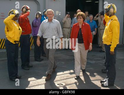 Stati Uniti Il Presidente George W Bush e la Louisiana Gov. Kathleen Blanco sono salutati come essi passano attraverso sideboys sul ponte di volo a bordo di un assalto anfibio nave USS Iwo Jima, 12 settembre 2005 a New Orleans, Louisiana. Bush e Blanco ha visitato l'Iwo Jima di essere informato sullo stato della Joint Task Force uragano Katrina i soccorsi. Foto Stock