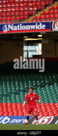 Aaron Ramsey del Galles in azione con uno stand vuoto lo sfondo Foto Stock