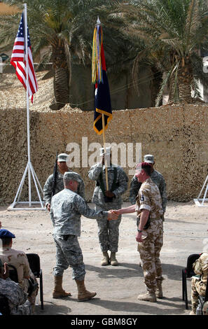 Il Comandante 20 ° Brigata blindata, Brigadier Tom Beckett (a destra) scuote le mani con il Comandante degli Stati Uniti, il colonnello Henry A Kievenaar III per segnare la mano del controllo militare a Basra agli americani a Basra Airbase, Iraq. Foto Stock