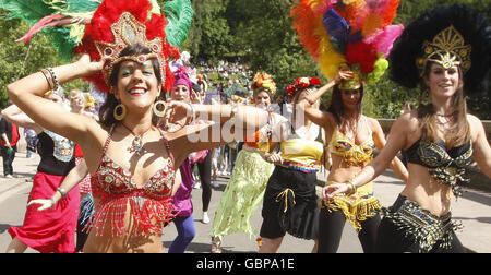 Ballerini mentre il West End Festival si svolge con 'Scotland's Mardi Gras', dove oltre mille artisti e band in costume hanno sfilato a Kelvingrove Park, Glasgow. Foto Stock