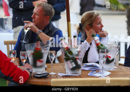 Lo champagne scorre al bar Champagne Mumm a Cowes Yacht Haven il terzo giorno della settimana dei Cowes, la regata velica di fama mondiale che si tiene ogni anno sul Solent, ma altrove gli incassi sono in calo. Oggi gli organizzatori hanno smesso di addebitare agli spettatori l'ingresso alle feste serali a causa della mancanza di commercio. PREMERE ASSOCIAZIONE foto. Data immagine: Martedì 4 agosto 2009. La recessione è stata accusato di aver registrato un calo di circa il 15% rispetto agli anni precedenti. Circa 900 yacht si contenderanno negli otto giorni di gara durante il 183° anno dell'evento. Il credito fotografico dovrebbe essere: Chris Ion/PA Wire Foto Stock