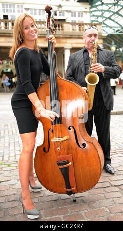 La socialite Tara Palmer-Tomkinson si unisce ad un improvvisato jazz 'sit in' suonando il contrabbasso con il musicista Greg Heath a Covent Garden Piazza, Londra, per lanciare 'PizzaExpress NeverEndingSong'. Foto Stock