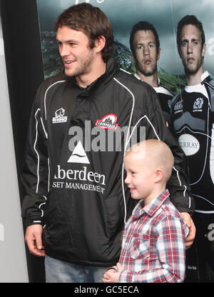 Alan McDonald di Edimburgo si pone per una foto con un giovane fan durante la cerimonia di laurea in allenatore di rugby apprendista a Murrayfield, Edimburgo. Foto Stock