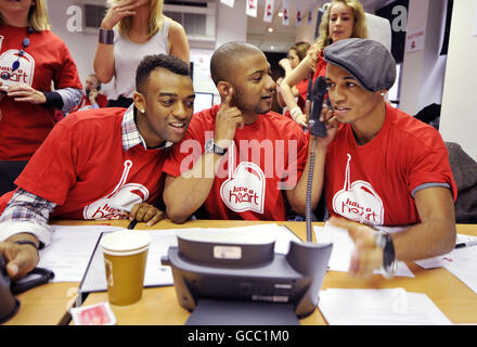 (Da sinistra a destra) Oritse Williams, JB, e Aston Merrygold di JLS rispondono ai telefoni durante la Have a Heart appeal, in aiuto della Starlight Children's Foundation, presso i Global radio Studios nel centro di Londra. Foto Stock