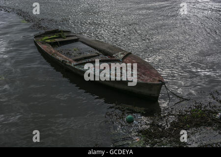 Naufragio della nave / mancanza di concetto aziendale, rappresentato dalla barca saturo di acqua /Hulk. Metafora per 'andare giù con la nave', la preparazione alle catastrofi concept Foto Stock