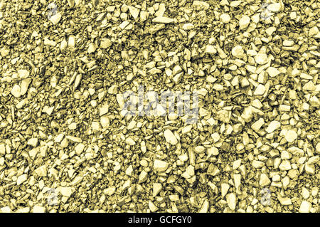 Ruvida giallo grigiastro mattone giallastro terreno shot principalmente uno sfondo grigio Foto Stock