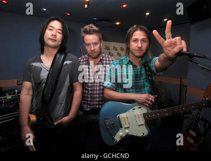 Feeder (da sinistra a destra) Taka Hirose, Karl Brazil e Grant Nicholas durante una sessione di studio XFM, a Leicester Square, nel centro di Londra. Foto Stock