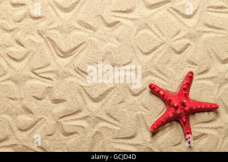 Starfish patterns con la rossa stella di mare sulla spiaggia di sabbia di background Foto Stock