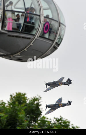 Uno Spitfire (fondo) e l'uragano dalla Battaglia di Gran Bretagna Memorial Flight passano dal London Eye durante un flypassato per celebrare il 70 ° anniversario della Battaglia di Gran Bretagna. Foto Stock