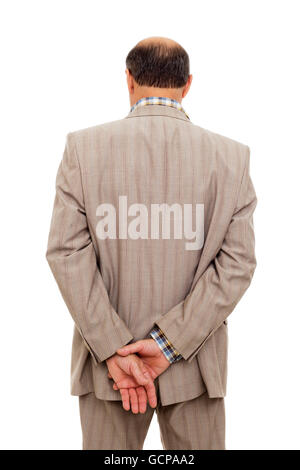 Uomo in tuta voltato le spalle, tenendo accuratamente il proprio polso Foto Stock