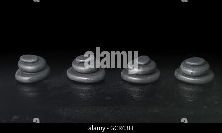 Spa concept della piramide zen pietre di basalto con gocce d'acqua su sfondo nero, close up Foto Stock