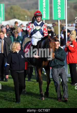 Noel Fehily su Sam Winner è condotto nella recinzione dei vincitori dopo la vittoria nella prova JCB Triumph Hudle durante il Paddy Power Gold Cup Day all'ippodromo di Cheltenham. Foto Stock