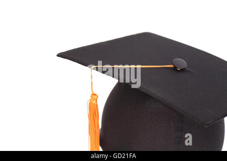 Graduazione nera Hat con oro fiocco isolato su sfondo bianco. Foto Stock