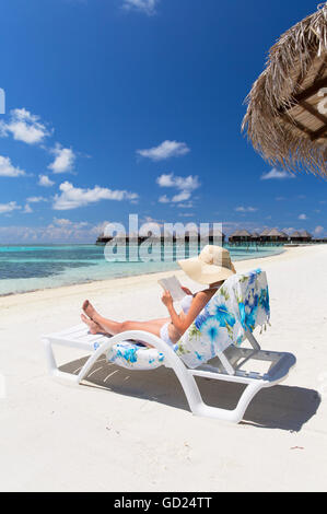 Donna sulla spiaggia a Olhuveli Beach and Spa Resort South Male Atoll, Kaafu Atoll, Maldive, Oceano Indiano, Asia Foto Stock