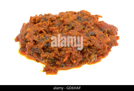 Una piccola porzione di pomodoro pesto con pomodori secchi e pinoli isolato su uno sfondo bianco. Foto Stock