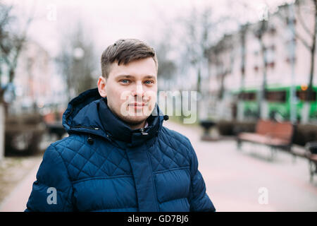 Giovane uomo bello in giacca blu all'aperto in stagione primavera Foto Stock