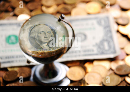 Globo di vetro e di riflessione del dollaro e con la pila di monete Foto Stock