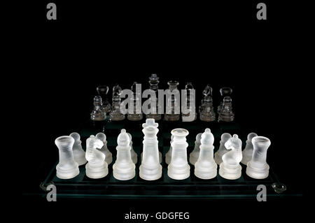 Scacchi di cristallo pezzi su una riga .su sfondo nero. Foto Stock