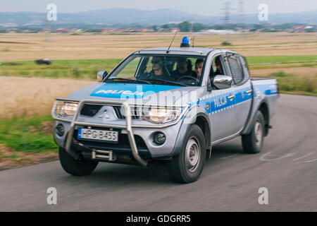 Polizia polacca pickup truck passare rapidamente attraverso i campi di grano. Foto Stock