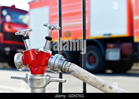 Il tubo flessibile di acqua collegata all'idrante antincendio durante il funzionamento Foto Stock