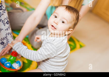 Baby boy gioca nella sua stanza. Foto Stock