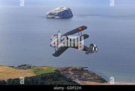 Gavin Hunter prende una pratica di volo in un Bucker Jungmann oltre il Bass Rock off la East Lothian coast in anticipo la sua apparizione in Nazionale Scozzese in Airshow East Fortune, East Lothian, sabato 23 luglio, dove egli si unirà una antenna line-up che include le frecce rosse, un RAF Typhoon e Swiss Air Force PC-7 team display, che sta facendo il suo debutto scozzese. Foto Stock