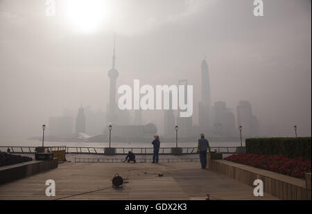 I lavoratori lavorano al Bund sotto aria inquinata al mattino Foto Stock