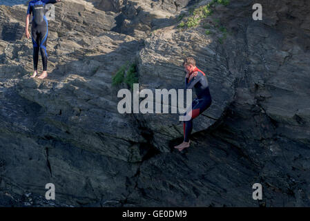 Un adolescente tombstoning off a strapiombo sul promontorio in Newquay, Cornwall. Foto Stock