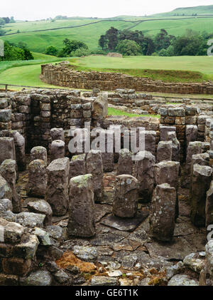 E Hypocaust pilae, terza Romana secolo bathhouse con il forte al di là. Vindolanda, Northumberland, England, Regno Unito Foto Stock