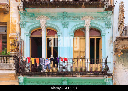 Servizio lavanderia asciugatura sul balcone ornato di un variopinto edificio storico nella Vecchia Havana, Cuba Foto Stock