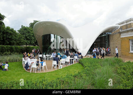 La gente in estate seduti ai tavoli esterno Zaha Hadid Sackler Serpentine Gallery ristorante edificio in Kensington Gardens LONDRA UK KATHY DEWITT Foto Stock