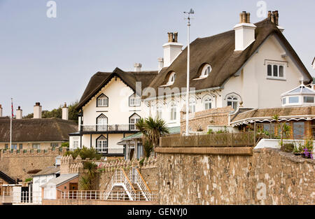 Regno Unito, Inghilterra, Devon, Sidmouth, lungomare con tetto di paglia di case sulla collina di picco strada si affaccia Clifton Beach Foto Stock