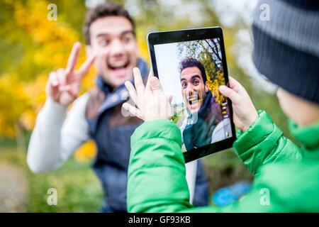 Modello rilasciato. Ragazzo tenendo la foto del padre. Foto Stock