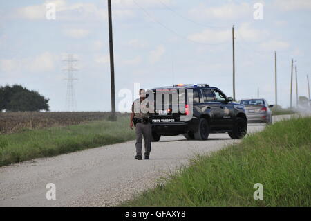 (160731) -- LOCKHART, luglio 31, 2016 (Xinhua) -- un funzionario di polizia lavora presso il sito di un palloncino crash incidente nei pressi Lockhart, una città nella parte centrale degli Stati Uniti di stato del Texas, 30 luglio 2016. Stati Uniti Texas Dipartimento della pubblica sicurezza ha confermato che 16 persone sono state uccise il sabato mattina dopo una mongolfiera ha preso fuoco e si è schiantato vicino Lockhart. L'incidente è avvenuto poco dopo le 7:40 a.m. ora locale di sabato nei pressi di Lockhart, quando la mongolfiera con almeno 16 persone a bordo si è schiantato in un pascolo, la Federal Aviation Administration (FAA) ha detto in una dichiarazione sul Saturda Foto Stock