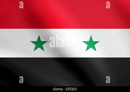 Bandiera della Siria sventolare nel vento con tessuto dettagliate texture. Siriano bandiera nazionale. Foto Stock