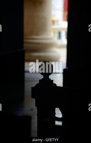 Wooden pew in a christian church, close up image in the shadows. Foto Stock
