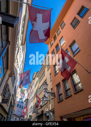 Gasse o un vicolo con le bandiere della Svizzera nella città vecchia di Zurigo, Svizzera, Europa Foto Stock