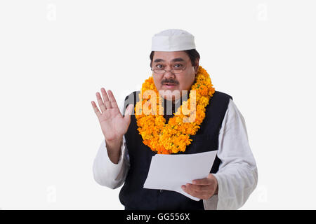 Ritratto di uomo politico tenendo il documento su sfondo bianco Foto Stock