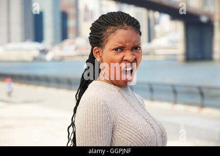 Donna nera con disgustato atteggiamento a waterfront Foto Stock