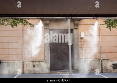 Tendaggio sprinkler gli spruzzi di acqua nebulizzata al bar sulla terrazza al fine di raffreddare la calda estate la temperatura in Spagna Foto Stock