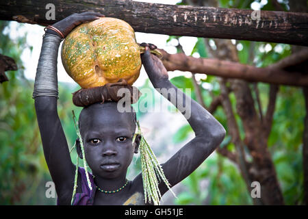 Giovane ragazza di Suri tribe con la zucca. Etiopia Foto Stock