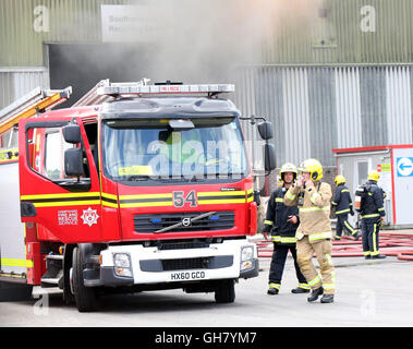 Marchwood, Hamphire, UK. 8 agosto 2016. Gli equipaggi di emergenza da Hampshire il fuoco e il servizio di soccorso e South Central servizio ambulanza rimanere presso la scena di un incendio che scoppiò subito dopo la pausa pranzo di oggi. Gli equipaggi di incendio sono state portate da un estremo di un campo come Portsmouth per affrontare il blaze all'incendio presso il centro di riciclaggio in East Road Marchwood. Otto motori Fire due aeree scale e l'incidente di unità di comando da Eastleigh stato portato a mettere fuori il fuoco. Credito: uknip/Alamy Live News Foto Stock