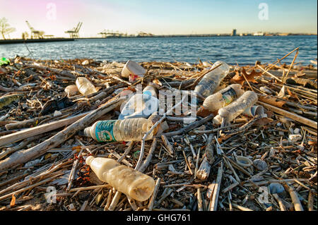 Vista di garbage principalmente bottiglie di plastica su una via navigabile nella zona industriale di New Jersey Foto Stock