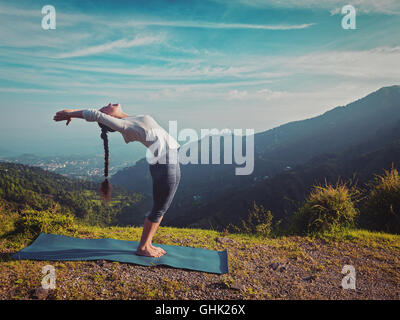 Donna fare yoga Sun salutation Surya Namaskar all'aperto Foto Stock