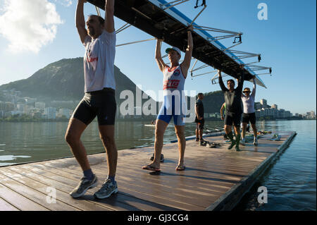 RIO DE JANEIRO - Aprile 1, 2016: Membri del Vasco da Gama rowing club portano la loro barca torna alla clubhouse a Lagoa. Foto Stock