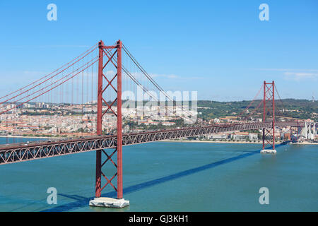 Il Ponte 25 de Abril attraverso il fiume Tago e vista sul centro di Lisbona, Portogallo Foto Stock