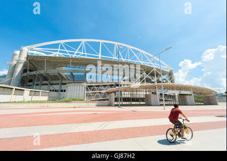 RIO DE JANEIRO - MARZO 18, 2016: un uomo brasiliano su una bicicletta passa di fronte al João Havelange Stadio Olimpico, Engenhão. Foto Stock